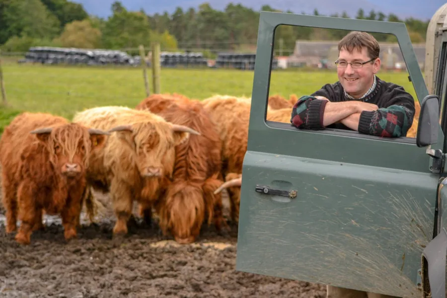 James Grant of Rothiemurchus Estate with a Highland cow